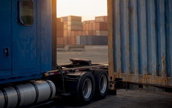 Close-up of truck connecting to shipping container