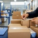 Warehouse worker sorting shipping packages