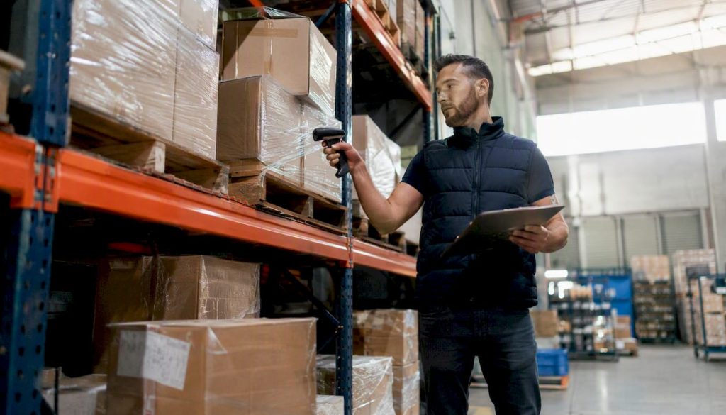 Warehouse worker scanning inventory boxes