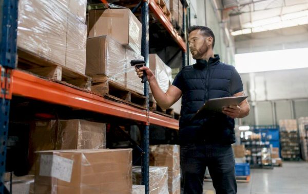 Warehouse worker scanning inventory boxes