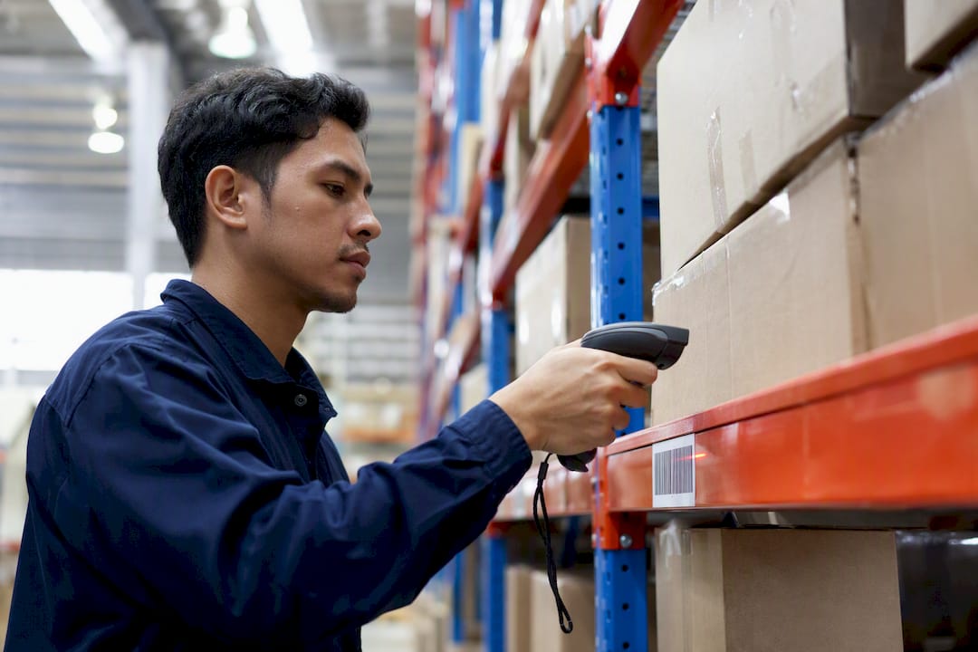 Worker scanning high velocity SKU in warehouse