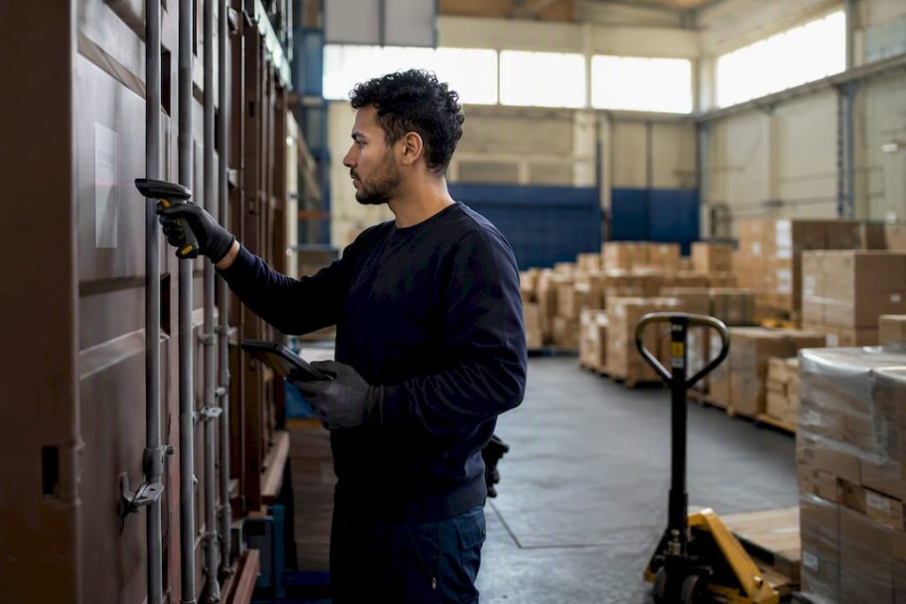 Worker scanning shipping container barcode