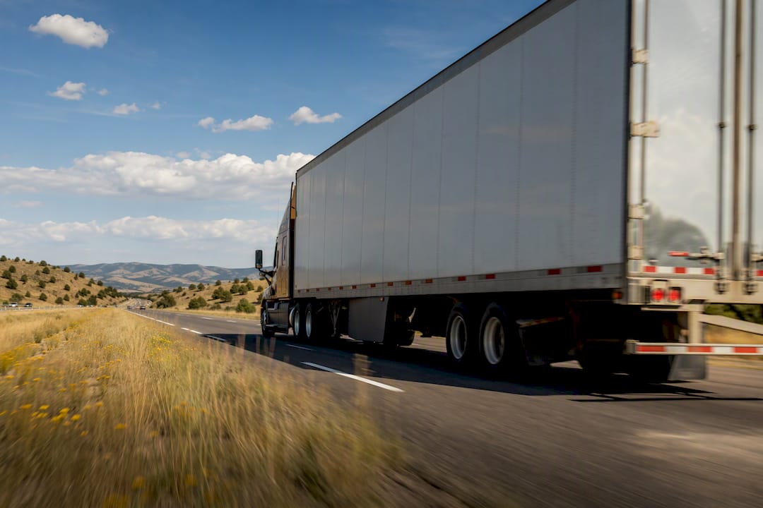 Semi truck trailer traveling on highway