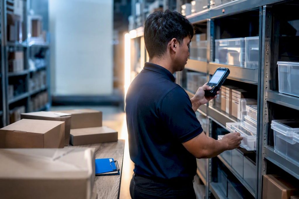 Worker verifying warehouse inventory count