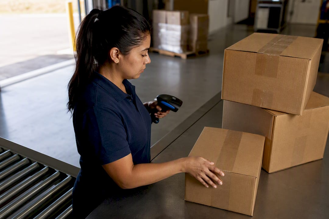 Associate counting cartons during warehouse receiving
