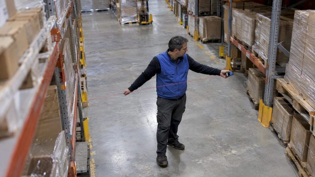 Planner measuring a warehouse storage aisle