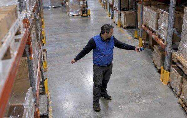Planner measuring a warehouse storage aisle