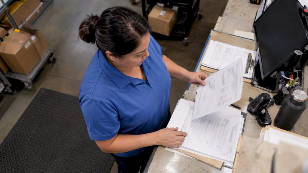 Freight coordinator checking a bill of lading