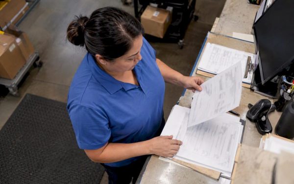 Freight coordinator checking a bill of lading