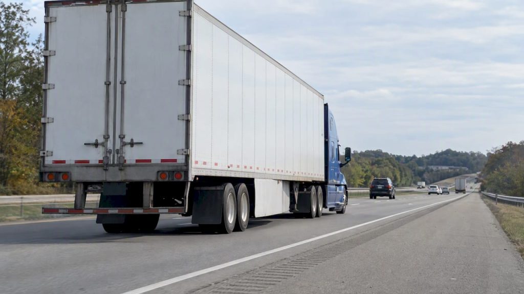 Loaded tractor-trailer traveling along an interstate