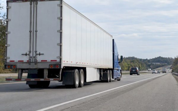Loaded tractor-trailer traveling along an interstate