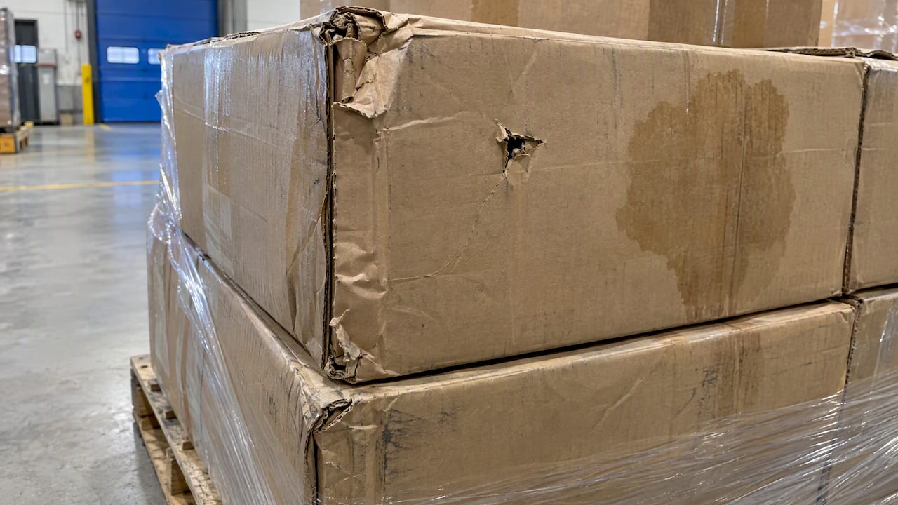 Crushed and water-marked cartons on pallet